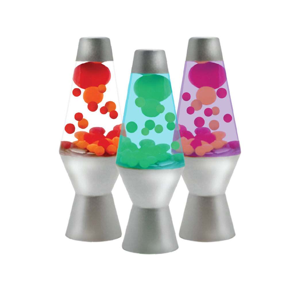Three small squishy toys in the style of a Motion Lamp with metallic silver bases arranged side by side. From left to right, the lamps contain red and orange, green and blue, and purple and pink illuminating liquid globs.