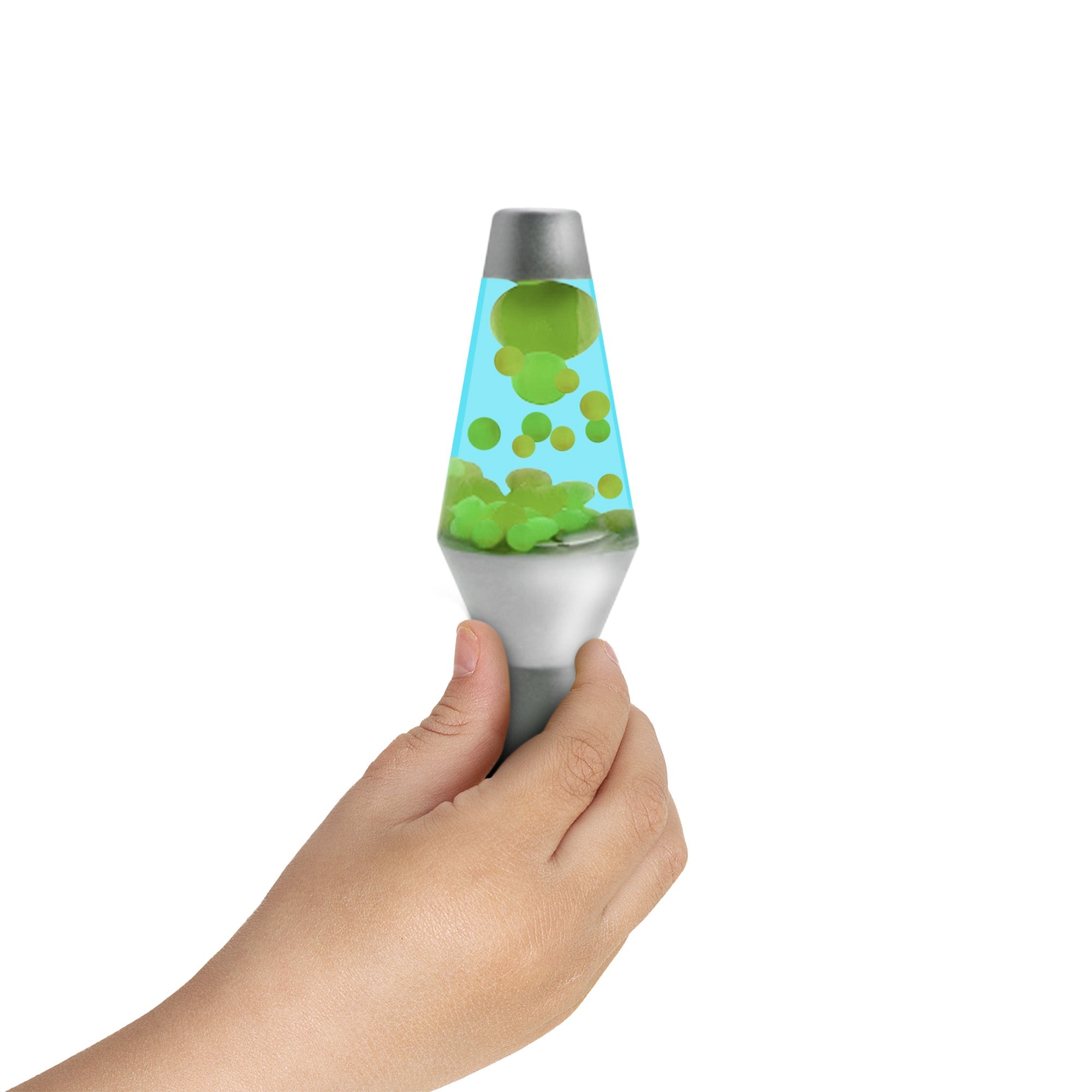A small hand holding a miniature Motion Lamp with green floating globs inside. The lamp has a silver base and cap, and the liquid inside is blue. The background is white.